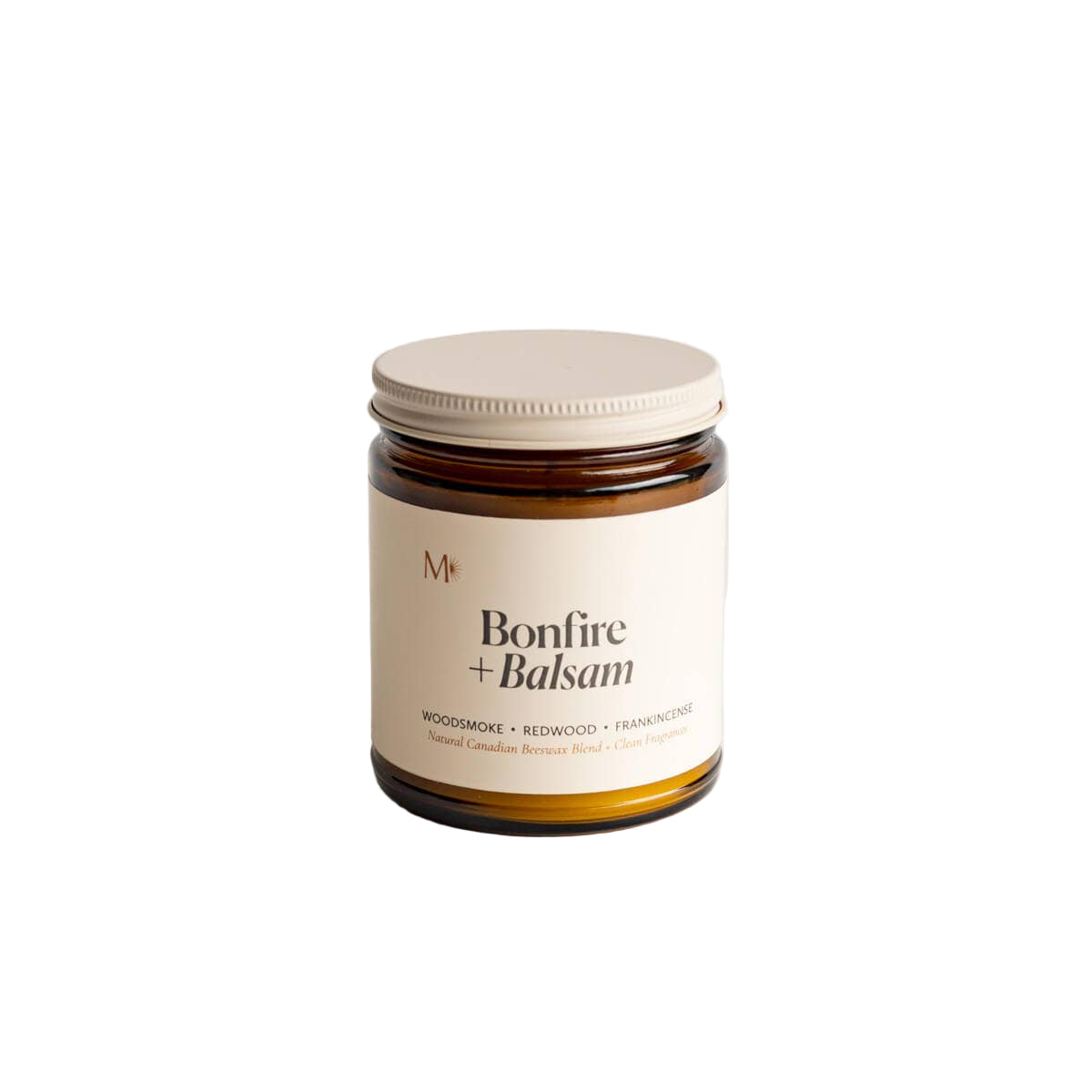 Candle jar labeled 'Bonfire + Balsam' on a white background