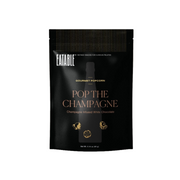 Black packaging of Eatable Gourmet Popcorn with 'Pop the Champagne' flavor on a beige background