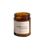 MISIYO sunlit peach + mango candle in an amber jar on a white background